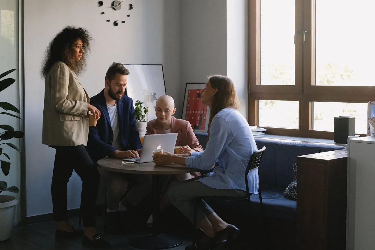 Diverse colleagues collaborating around a laptop on platform integration