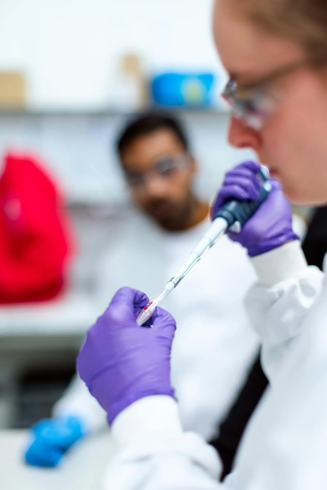 Scientist working with a pipette in a modern research laboratory