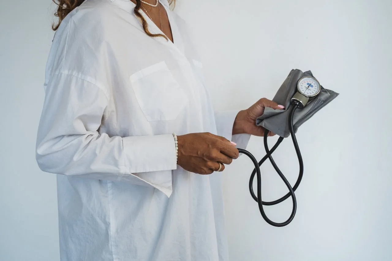 Woman self-monitoring with a blood pressure monitor at home
